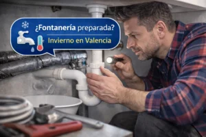 Fontanero revisando tuberías bajo un fregadero para preparar la fontanería de una vivienda para el invierno en Valencia